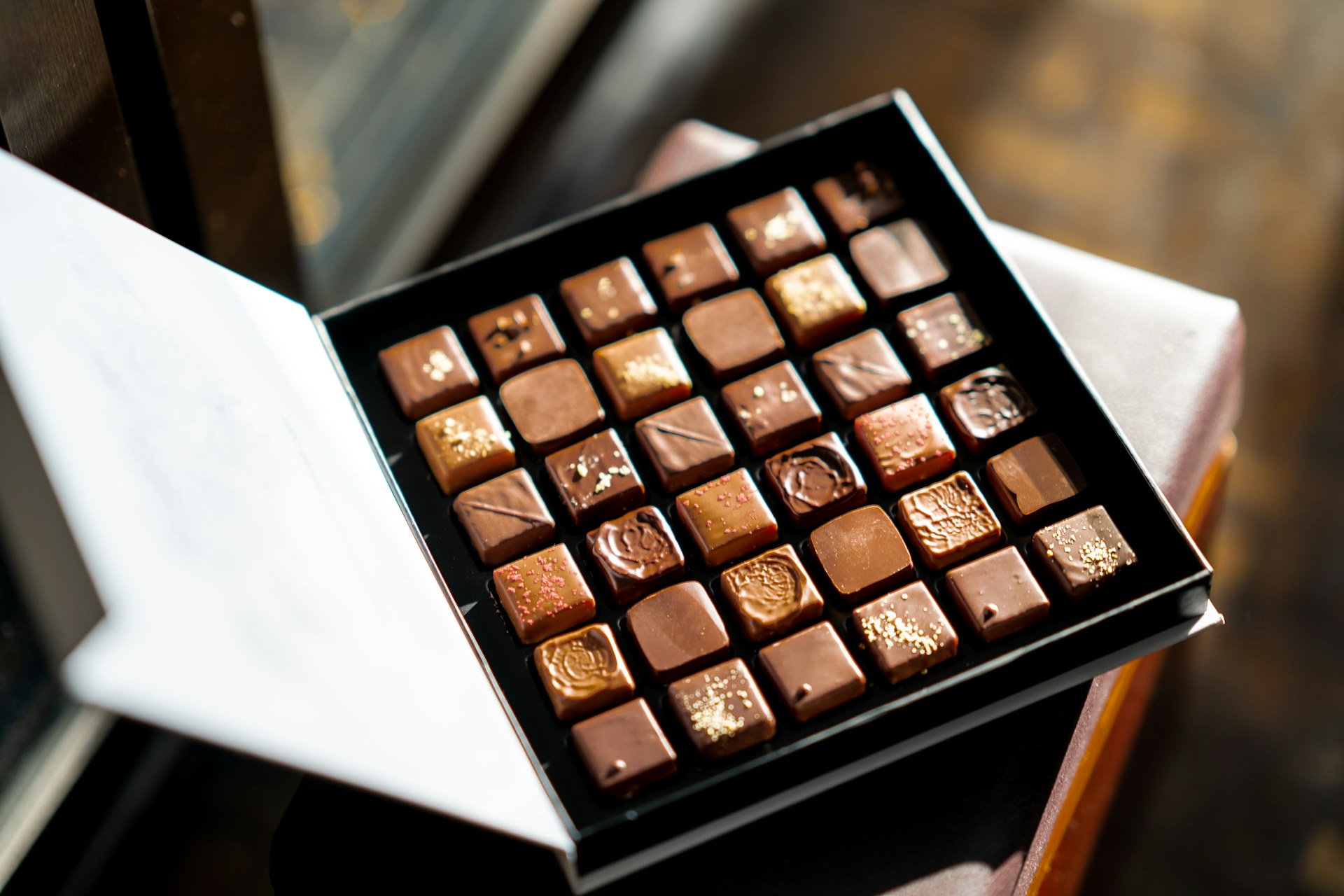 An open gift box of assorted chocolates